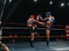 Pippa King kicking Kristy Obst at Epic 15 by Emanuel Rudnicki Fight Photography