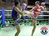 Claire Baxter kicking Maesa Tor. Buamas by Santai Muay Thai