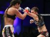 Colleen Schneider punching Raquel Pa'aluhi at Invicta FC15 by Scott Hirano