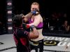 Latoya Walker punching Peggy Morgan at Invicta 12 by Scott Hirano