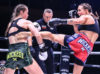 Niamh Kinehan catches Sarah Worsfold's kick at Muay Thai Grand Prix X, 9 October 2021 by Rakowska Photography